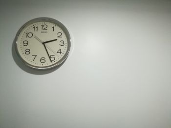 Low angle view of clock on wall