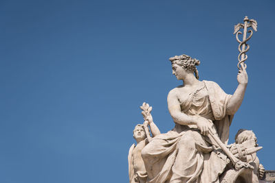 Low angle view of statue against clear blue sky