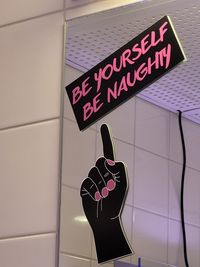 Low angle view of text on wall