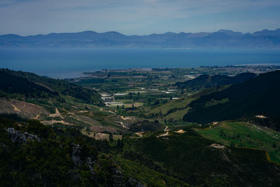 High angle view of landscape and sea against sky