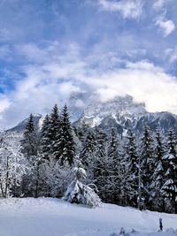 Scenic view of snow covered mountains against sky