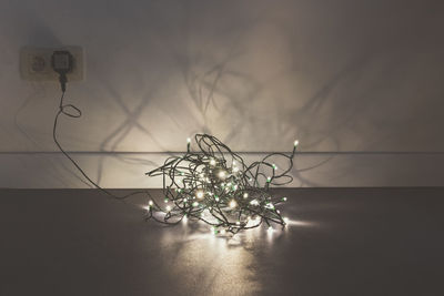 View of fairy lights on ground indoors
