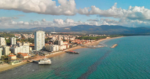 Panoramic view of sea and buildings against sky