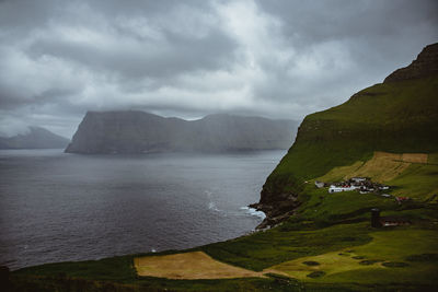 Scenic view of land and mountains against sky