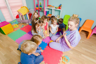 High angle view of people sitting on floor