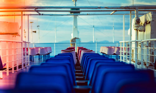Seats in ship against sky