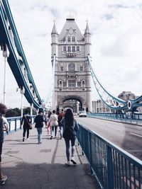 People on walking on tower bridge against sky