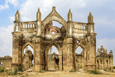 Old ruins of building against cloudy sky