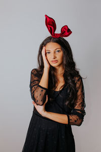 Portrait of a beautiful young woman against white background