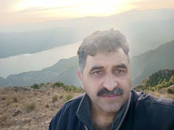 Portrait of man in mountains against sky