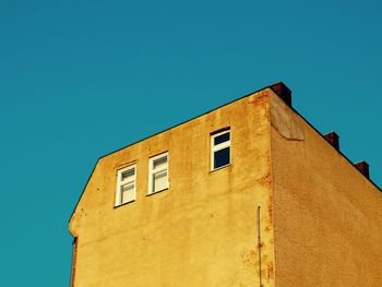 Low angle view of built structure against clear blue sky