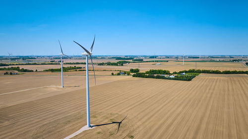 Scenic view of agricultural field against clear blue sky