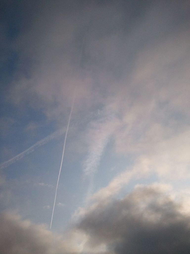 low angle view, sky, cloud - sky, tranquility, beauty in nature, cloudy, scenics, nature, tranquil scene, cloud, sky only, outdoors, vapor trail, cloudscape, no people, blue, idyllic, power line, day, weather