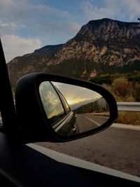 Reflection of mountains on side-view mirror