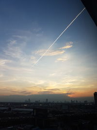 Vapor trails against sky during sunset