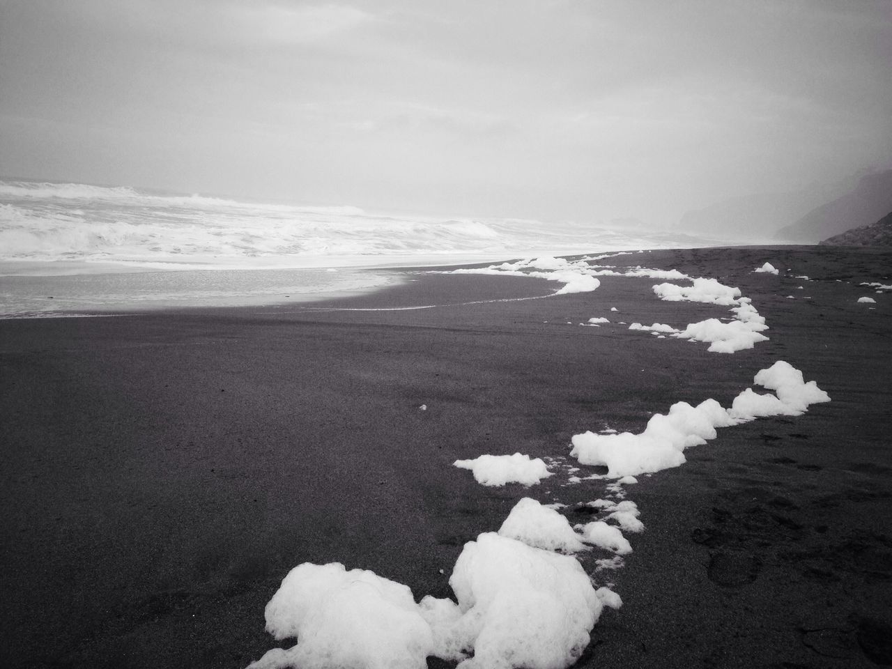 beach, sea, tranquility, tranquil scene, scenics, shore, sky, beauty in nature, horizon over water, nature, water, sand, weather, cold temperature, winter, snow, idyllic, surf, remote, non-urban scene