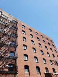 Low angle view of building against clear blue sky