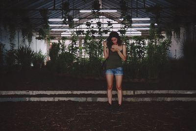 Young woman standing on footbridge