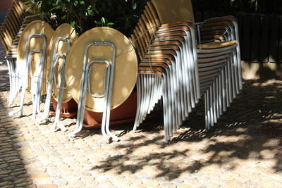 Row of chairs on footpath at beach