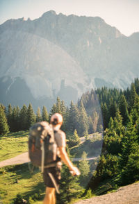 Rear view of man standing on mountain