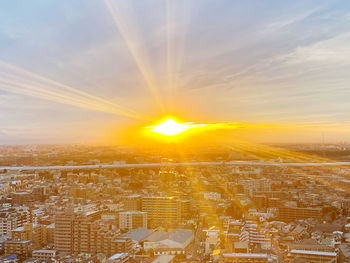 Aerial view of city against sky during sunset