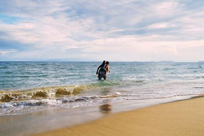 Full length of person on beach against sky