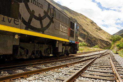 Train on railroad tracks against sky