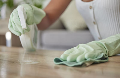 Midsection of man cutting onion on table