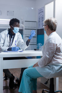 Male doctor advising female patient in clinic