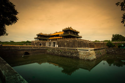 Reflection of building in lake at sunset