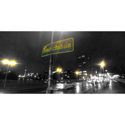 Illuminated city street against clear sky