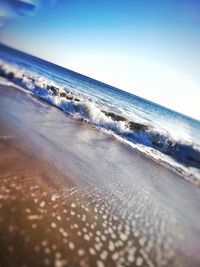 Scenic view of beach against blue sky