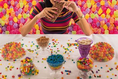 High angle view of woman eating chocolate at table