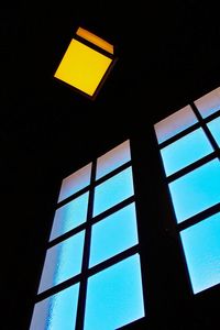 Low angle view of modern building against blue sky