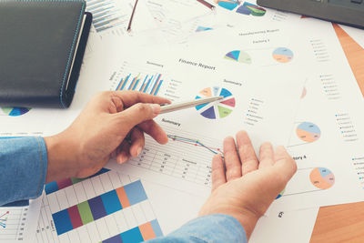 Close-up of businessman analyzing document in office