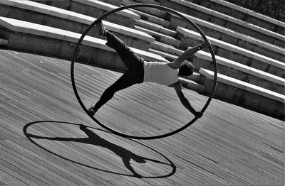 Artist performing with giant ring at park