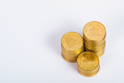 High angle view of coins on white background