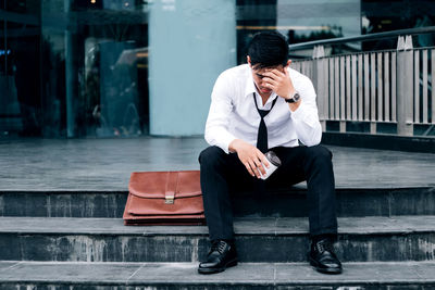 Young man using mobile phone in city