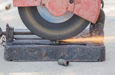 Rebar is being cut with a tool for cutting steel.