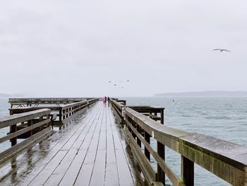 View of pier on sea against sky