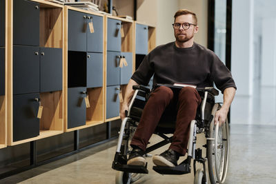 Disabled businessman sitting on wheelchair at office