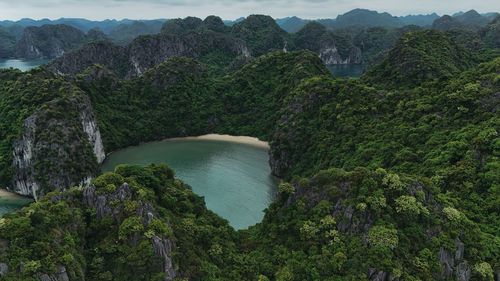 Scenic view of river amidst mountains against sky