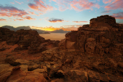 Rock formations against sky during sunset