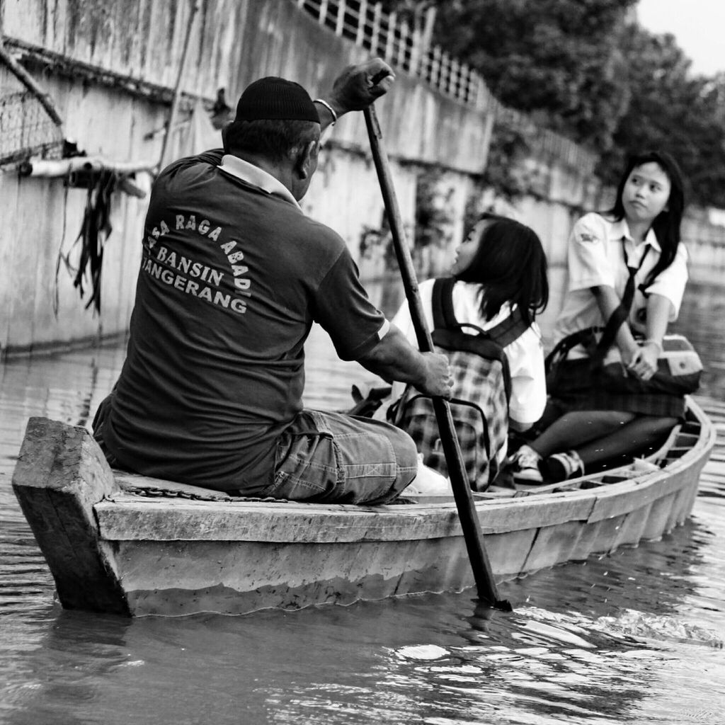 lifestyles, leisure activity, water, men, casual clothing, full length, togetherness, young men, bonding, nautical vessel, sitting, love, person, boys, boat, transportation, occupation