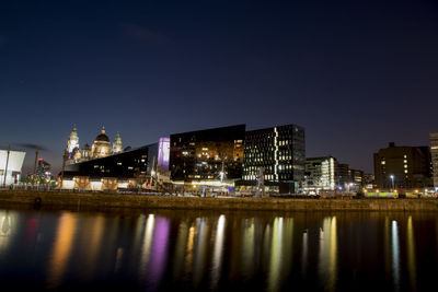 Reflection of illuminated buildings in water at night