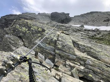 Low angle view of rocks on mountain against sky