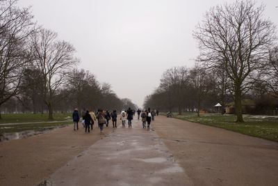 Group of people walking on footpath in park