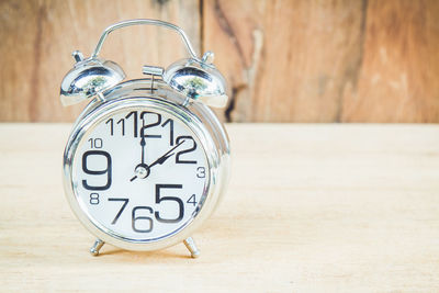 Close-up of alarm clock on table