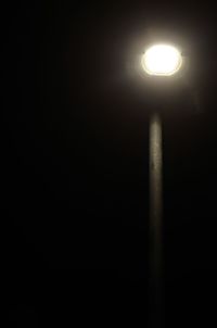 Low angle view of illuminated lights at night