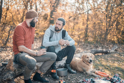 Men sitting with dog